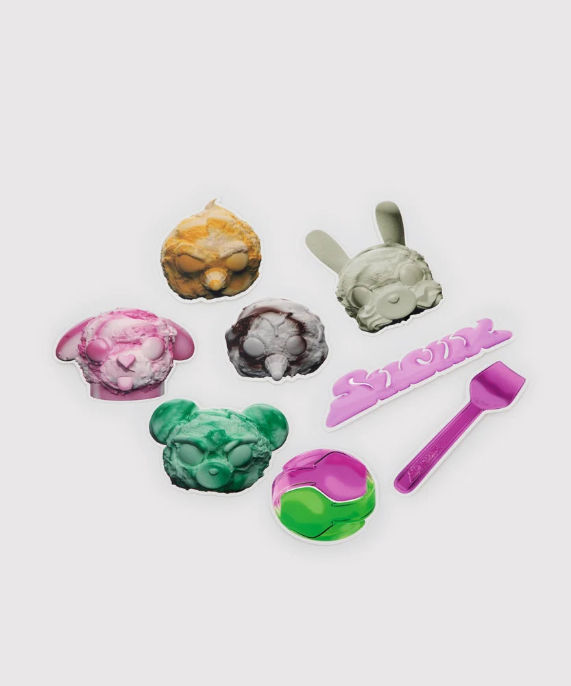 Colorful sticker set featuring ice cream-inspired animal heads in various colors and shapes, a pink ‘Sucux’ logo sticker, a glossy pink scoop utensil, and a two-tone pink and green ball – part of the Sucux Cool Collection.