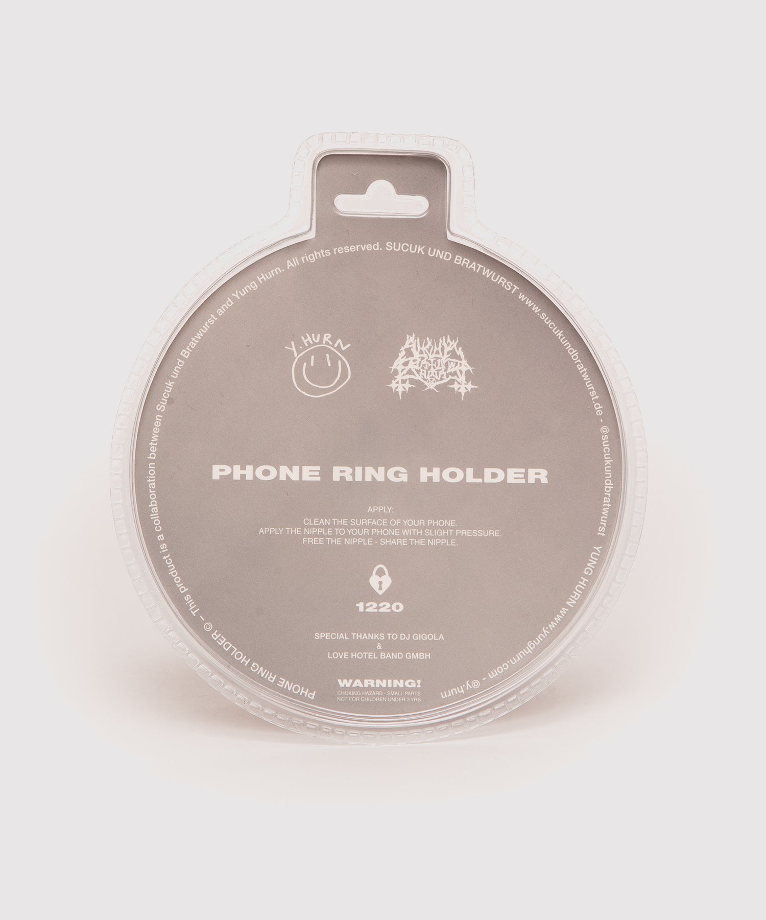 Back side of the Nipple Phone Ring Holder packaging. Features usage instructions, logos of Yung Hurn and Sucuk und Bratwurst, a note on the collaboration, and credits to DJ Gigola and Love Hotel Band GmbH. Includes a warning about small parts and not suitable for children under 3 years.