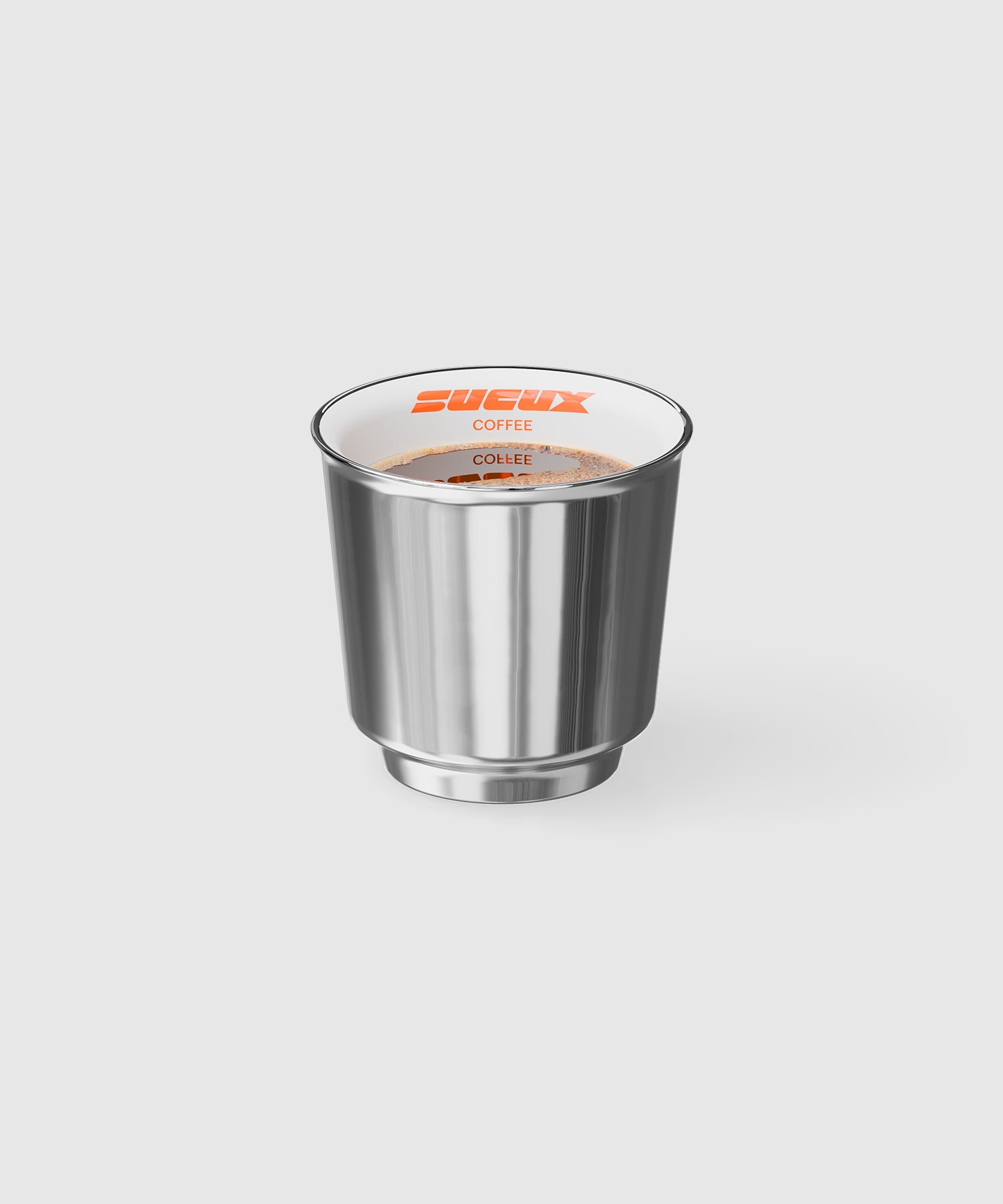 Porcelain espresso cup with a glossy chrome finish, filled with coffee. The interior rim is white and features the orange SUCUX COFFEE logo. The minimalist design reflects a futuristic, industrial aesthetic.