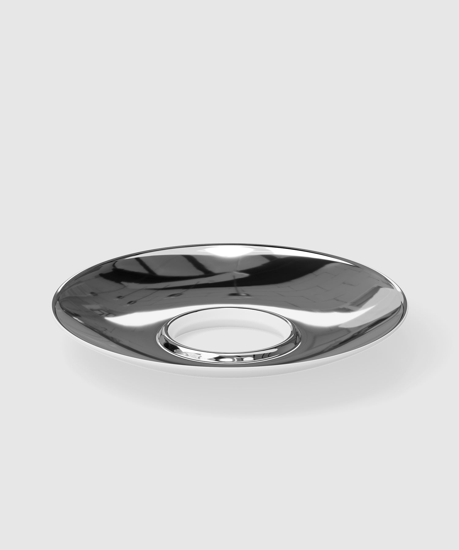 Glossy chrome-finished porcelain saucer with a recessed center designed to hold an espresso cup. The futuristic and reflective surface gives it a sleek, industrial appearance.